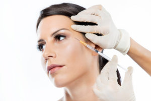 beautiful young woman getting botox cosmetic injection in her face1